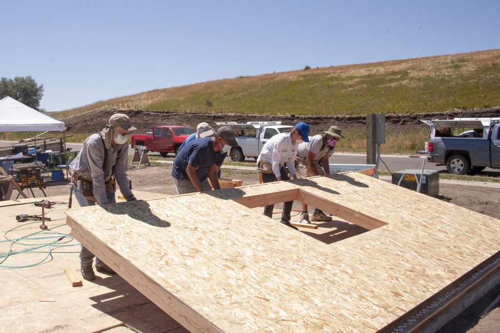 Habitat volunteers raising the first wall of the 2020 Uniontown home