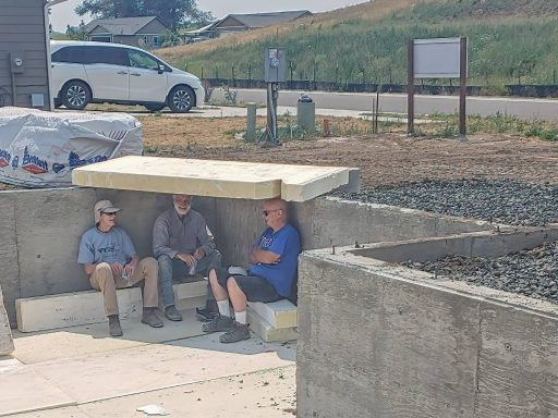Build Site Volunteers enjoy some make-shift shade during a break.