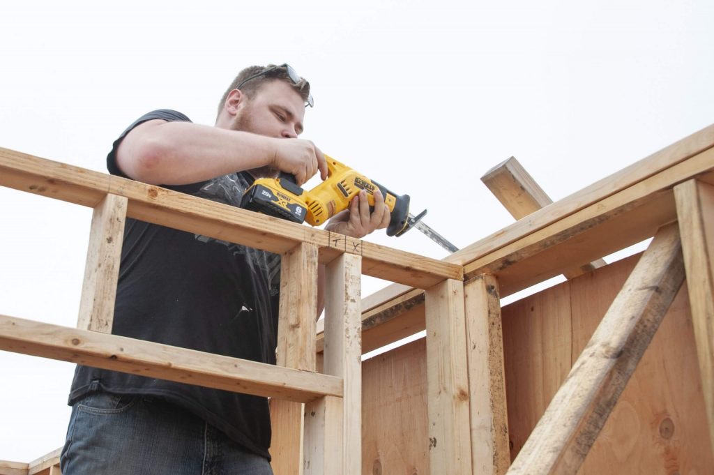 Volunteer Clement Making Room for a Top Plate at the Build Site