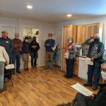 Volunteers gather in the Leaseburg home for the start of the Home Dedication Event