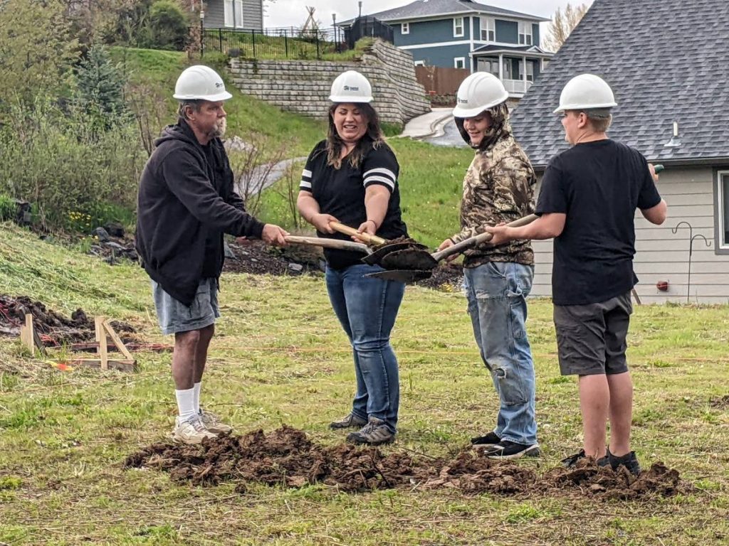 Volunteers break ground at a local build site.