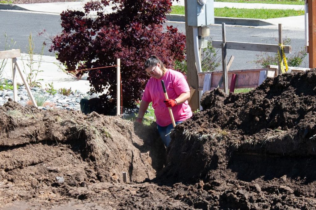 One of PHFH's volunteers, Aimee, Working on the Power Ditch at the build site.